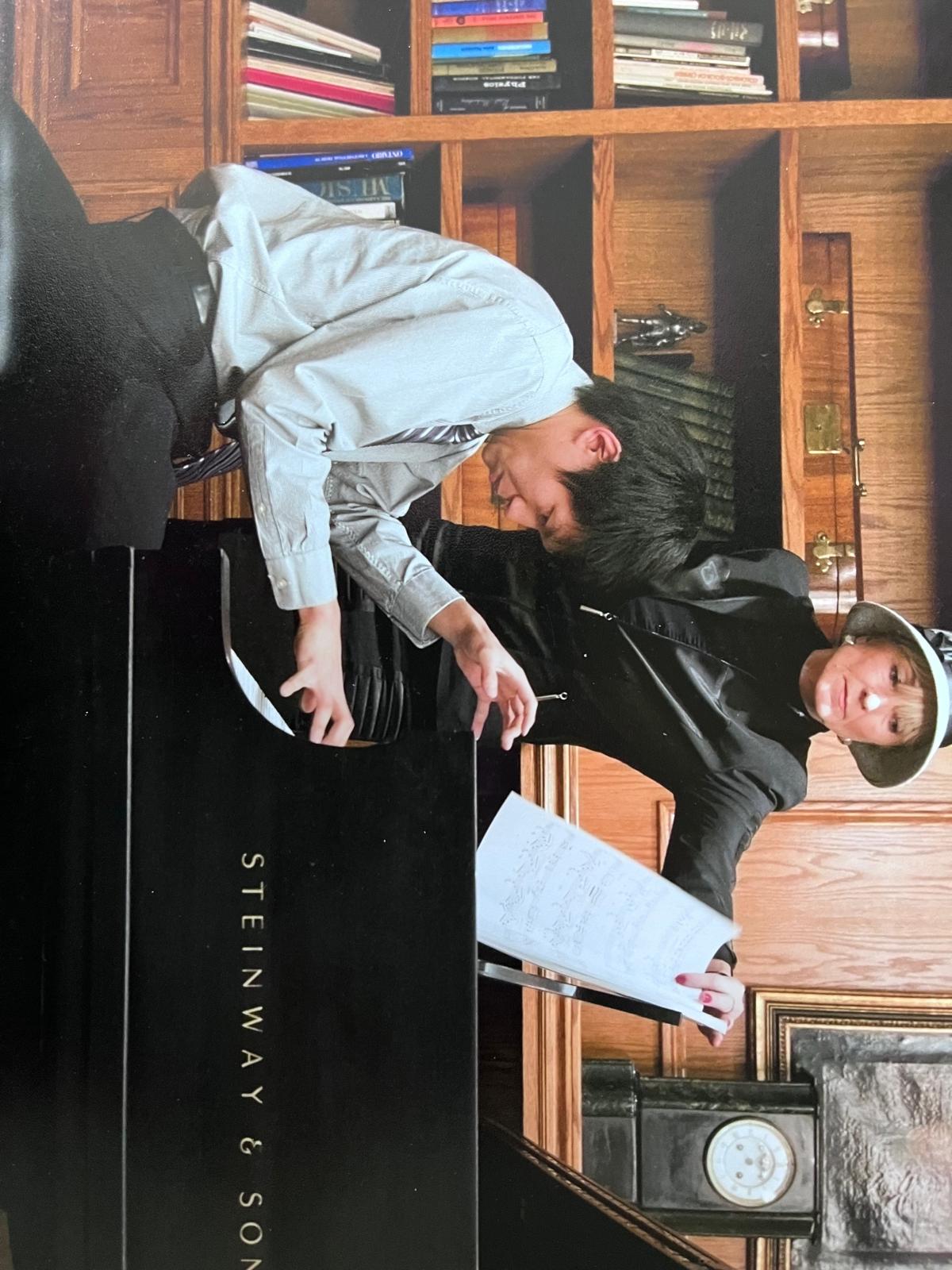 Valentina coaching a student in performance posture at the Steinway